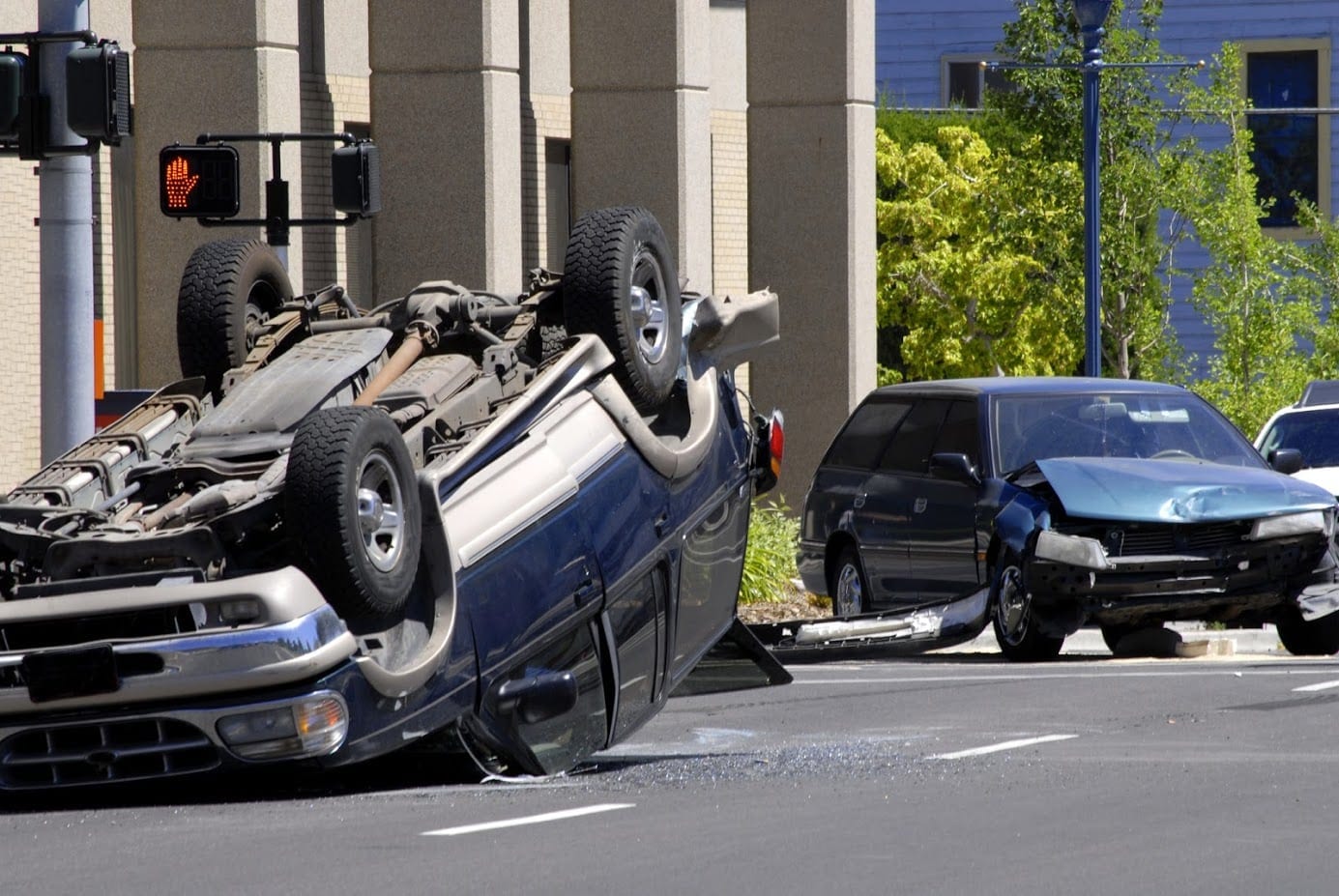 Rollover Car Accident On A Busy City Street Stock Photo