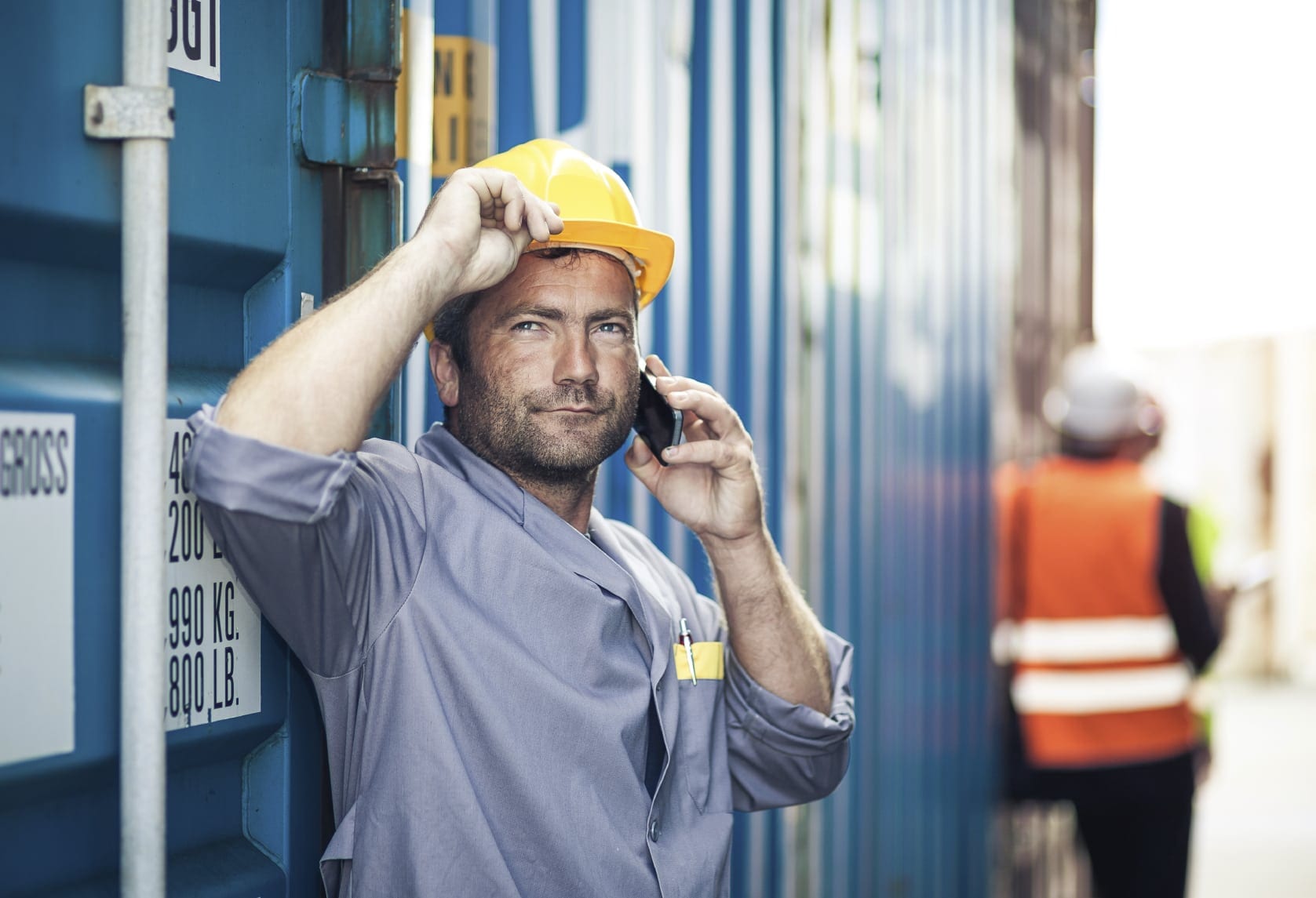 Construction Worker Talking On Smart Phone Stock Photo