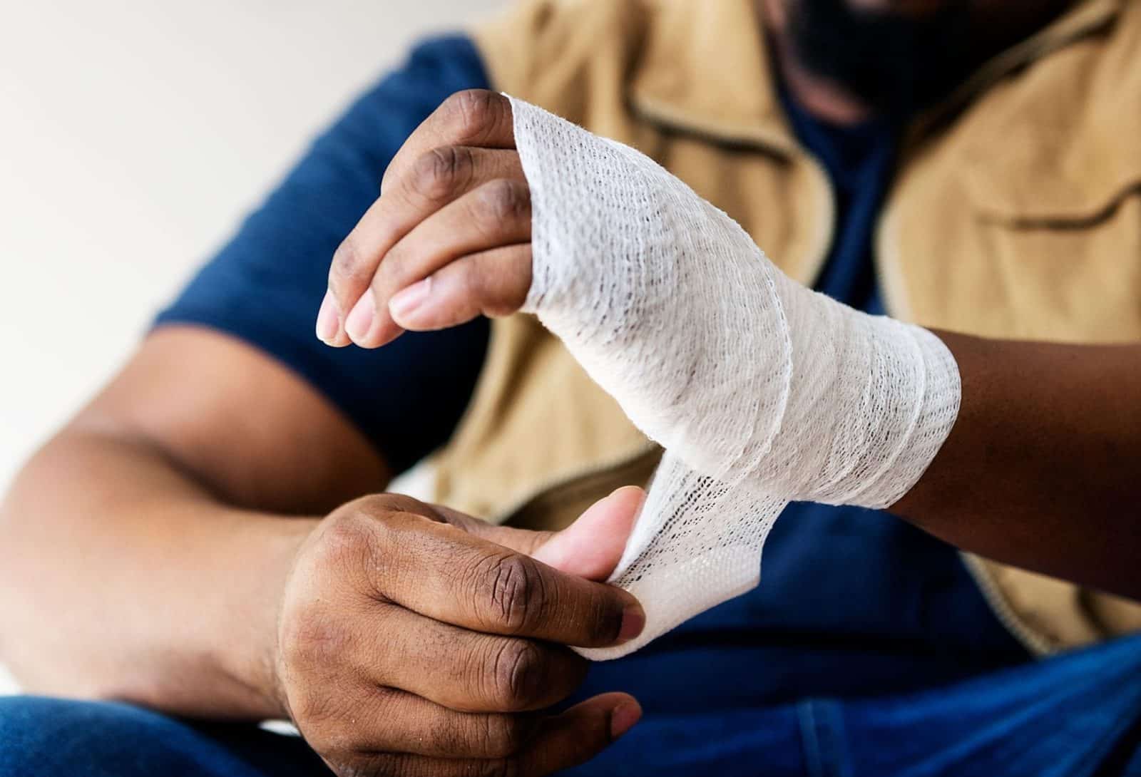 Man With Injured Hand Wrapped In Bandage Stock Photo