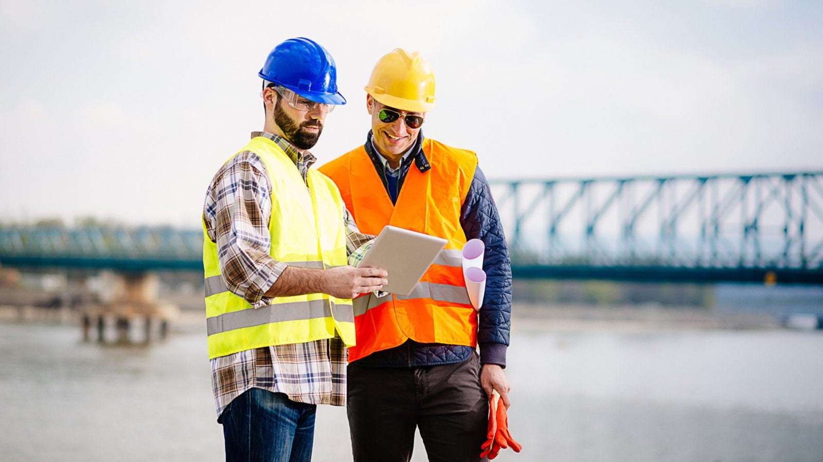 Two Construction Workers Examining A Tablet Stock Photo