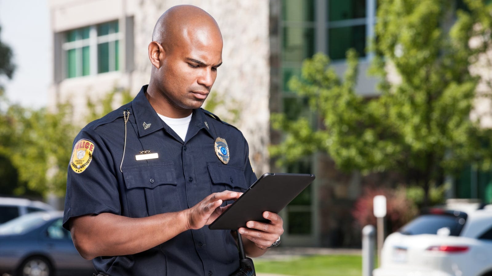 Police Officer Completing A Police Report Stock Photo