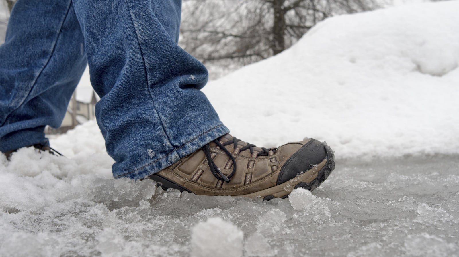 Man Walking On An Icy Sidewalk Stock Photo