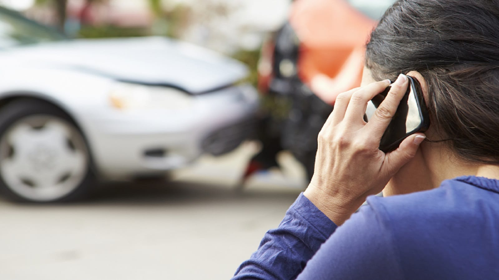 Female Driver Reporting A Car Accident Stock Photo