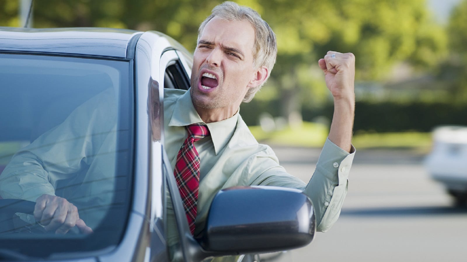Angry Male Driver Shouting At Other Drivers Stock Photo