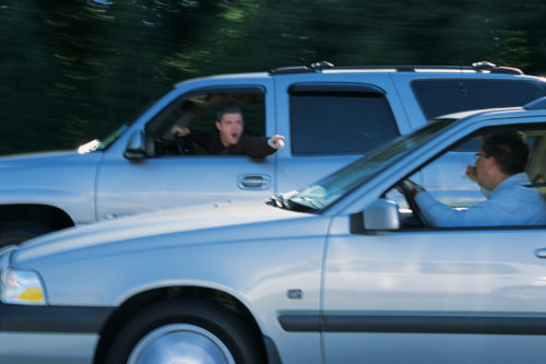 Men arguing with each other from their vehicles while driving