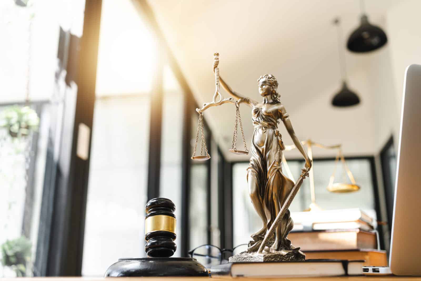 A gavel and books over workers compensation claims sit on the desk of an experienced attorney in Colorado Springs.