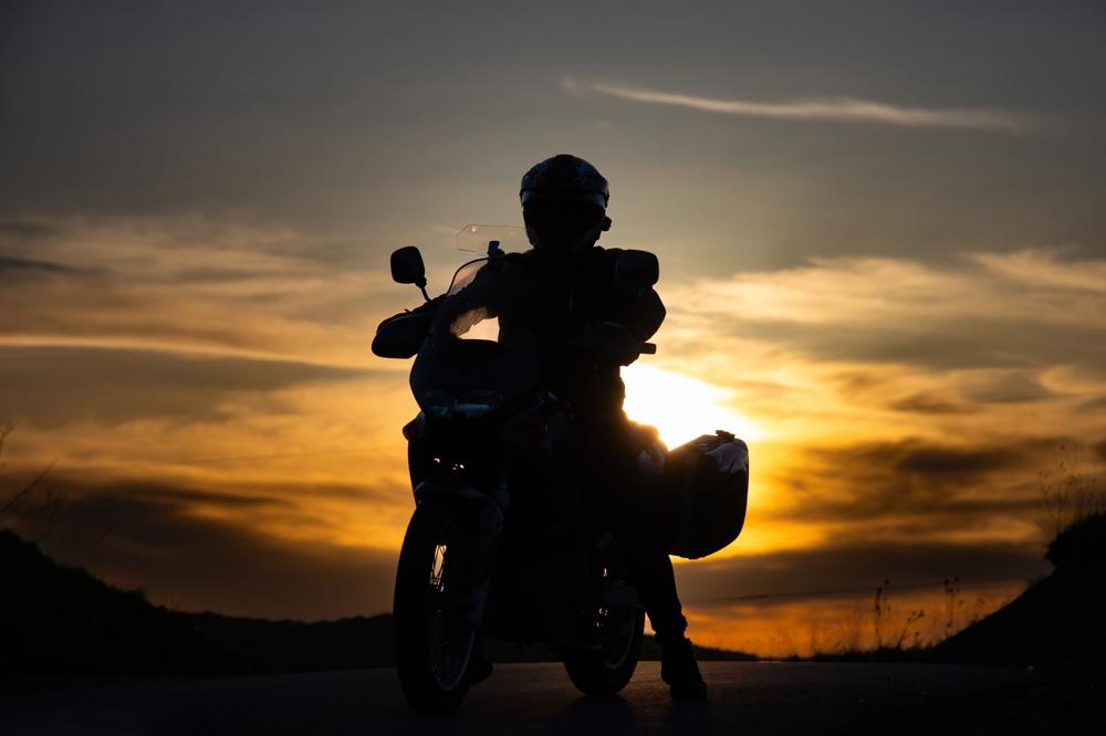 A biker sitting on a motorcycle. Review six questions to ask your motorcycle accident lawyer.