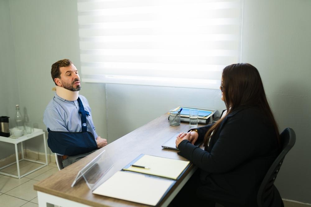 Lawyer meets with client to explain settling a slip and fall case out of court.